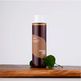 Bottle of green tea fresh water on a wooden surface with a white background