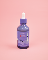 Purple bottle with dropper on a pink background
