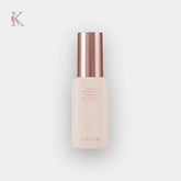 Skincare bottle with rose gold cap on a light gray background