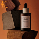 Skintox bottle of Karagafica Centella on a wooden block with a brown background