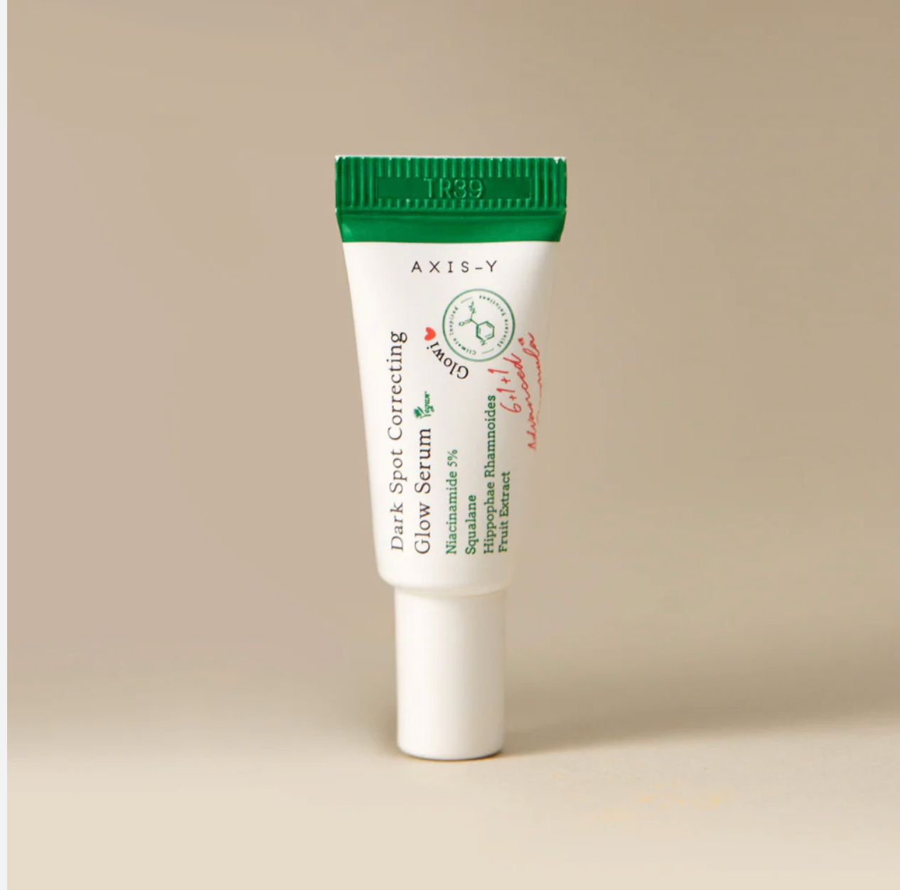 AXIS-Y Dark Spot Correcting Glow Serum 5ml mini tube with green cap on beige background
