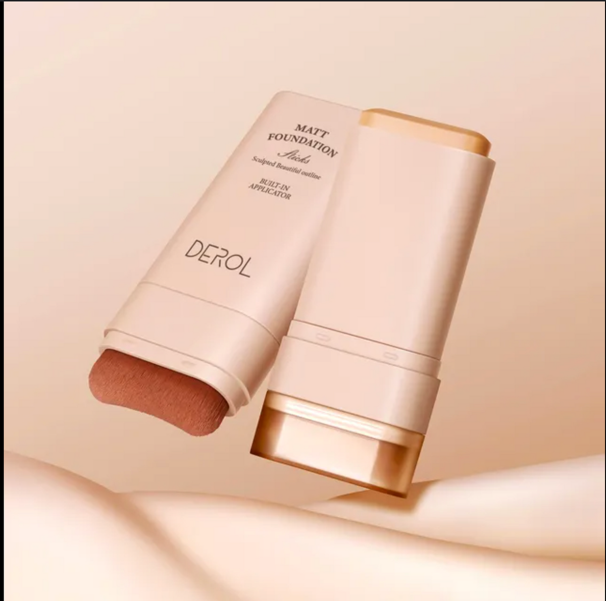 Two DEROL foundation sticks on a beige background