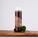 Bottle of green tea fresh water on a wooden surface with a white background